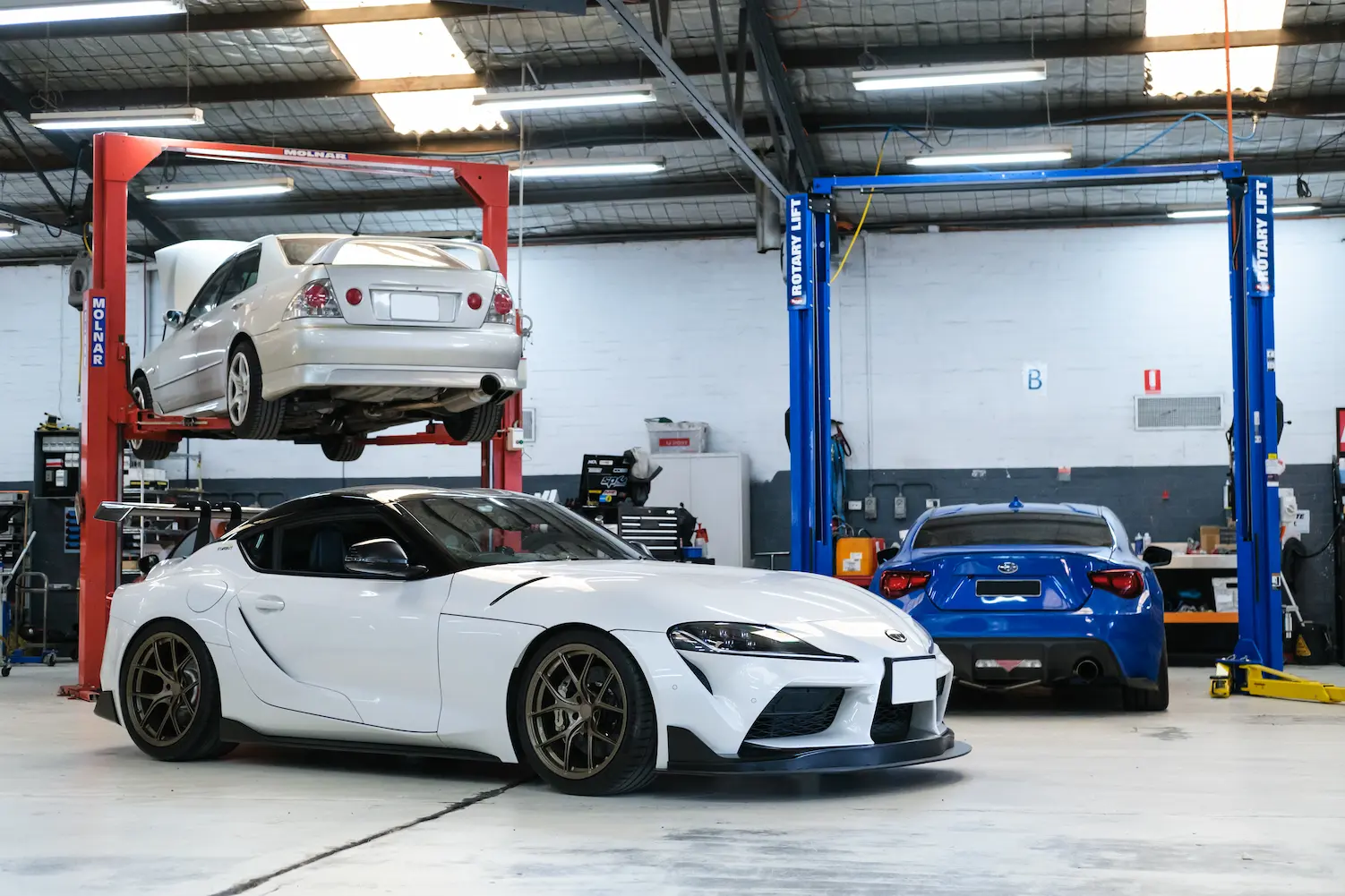 3 performance vehicles in workshop